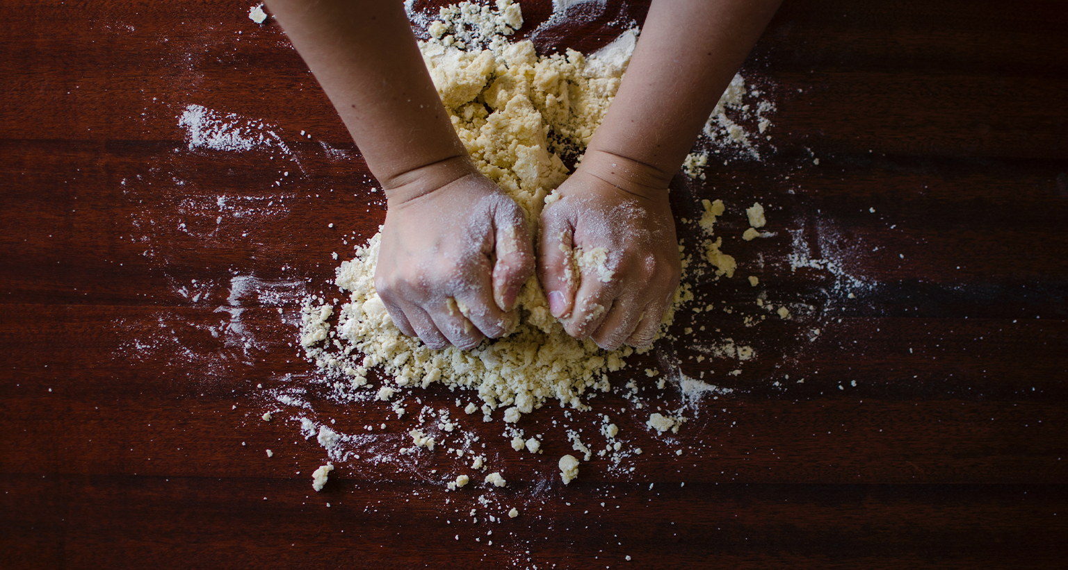 person kneading bread