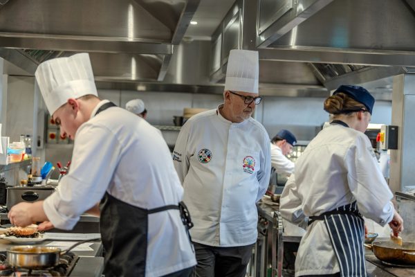 Arwyn Watkins OBE, Culinary Association of Wales president, judging the Skills Competition Wales Culinary Arts competition