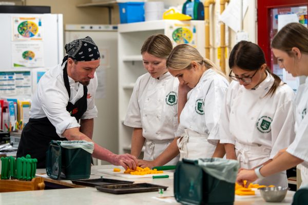 A Cambrian Training Company training officer with pupils studying for a GCSE in Food Preparation and Nutrition