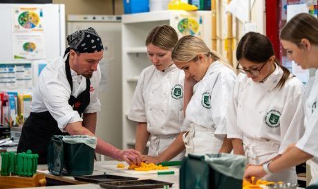 A Cambrian Training Company training officer with pupils studying for a GCSE in Food Preparation and Nutrition